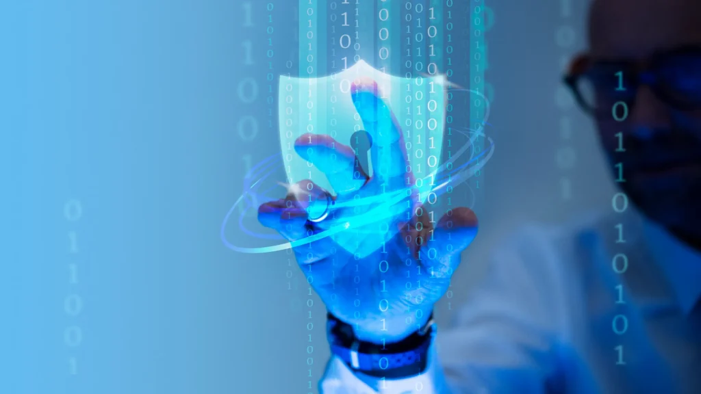Conceptual image of digital cybersecurity showing a glowing shield overlay and binary code.